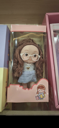 Cute 6-Inch Miniature Girl Doll with White Glasses – Adorable Curly Brown Hair Doll in Blue Heart Sweater and Plaid Skirt