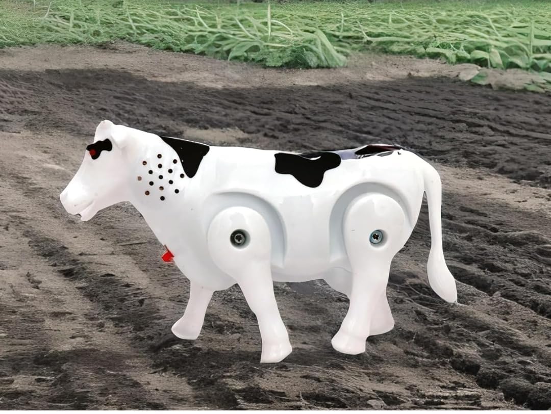 Two views of a white and black toy cow with labels indicating "Light," "Sound," "On/Off Switch," and "Moving Leg." The bottom view shows the open battery compartment, labeled "Used Battery AA (Battery Not Included)