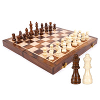 A close-up view of a wooden foldable chessboard with light and dark squares, featuring a set of wooden chess pieces. Inset circles highlight a "Durable Hinge," "Sturdy Metal Clasp," and "Smooth Edges" of the board. The logo "ADA Handicraft" is in the top left corner.