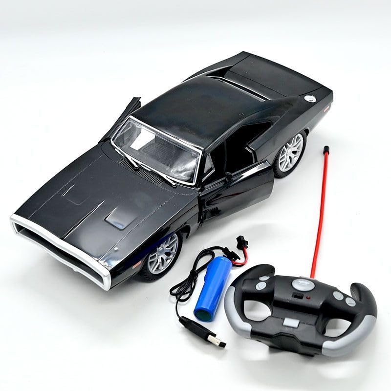 An overhead view of a black MOKA remote control toy car, resembling a classic muscle car, with its front doors open. Alongside the car are its accessories: a black and silver steering wheel-shaped remote control with a red antenna, and a blue rechargeable battery pack with its charging cable, all arranged on a white surface.